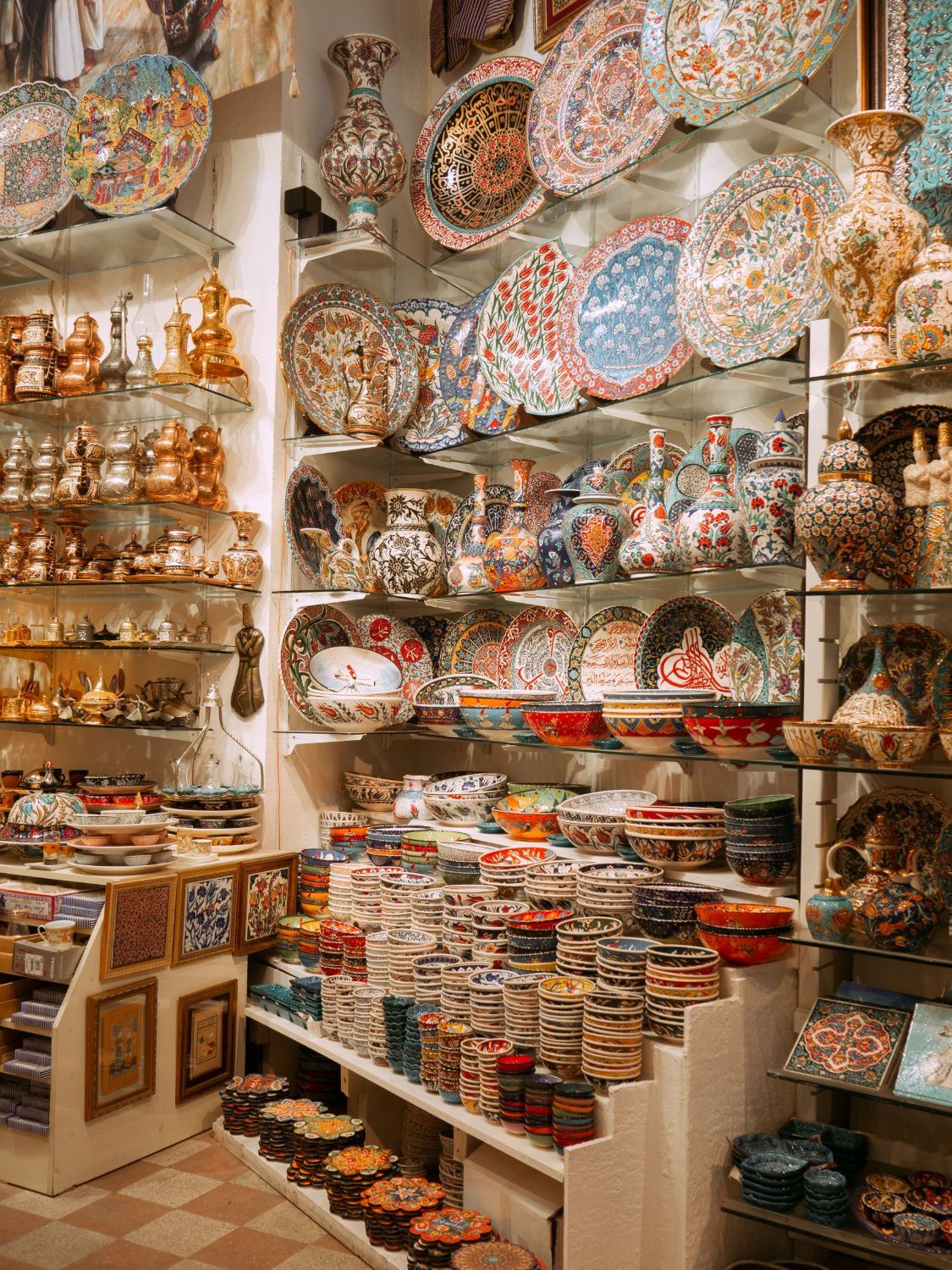 Decorative ceramics, plates and metalware on display